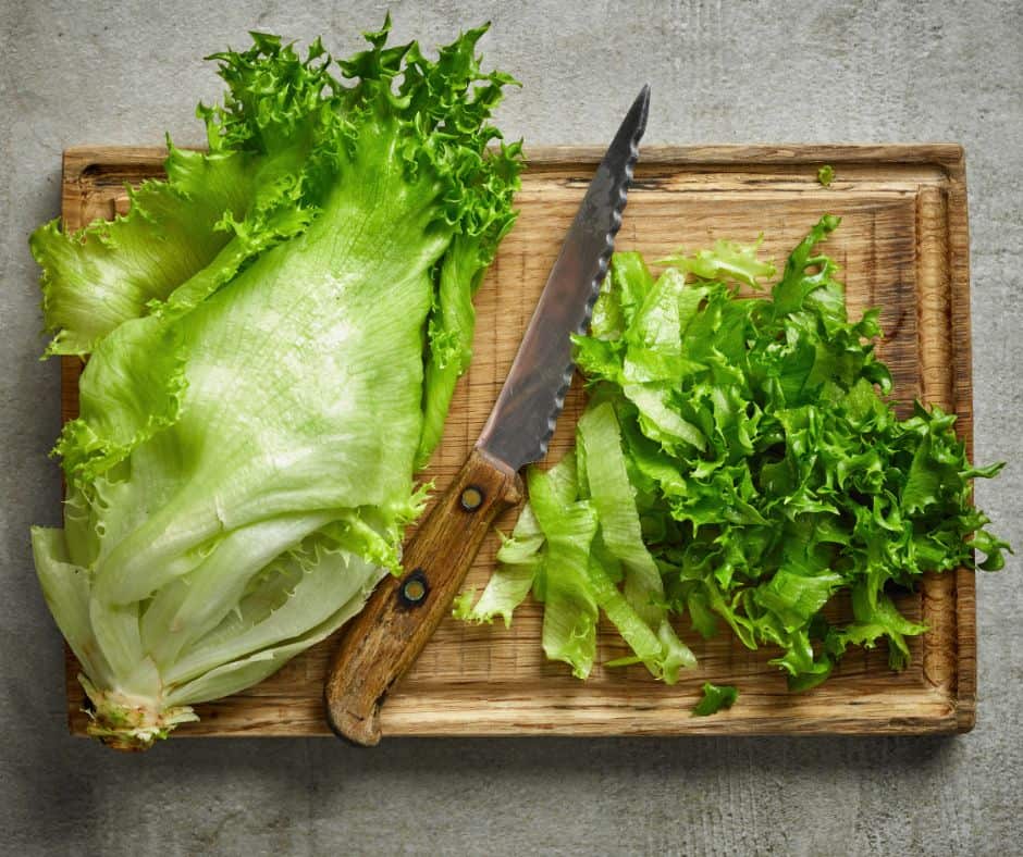 Preparing lettuce on a wooden cutting board instead of plastic Wooden cutting board is safer than plastic